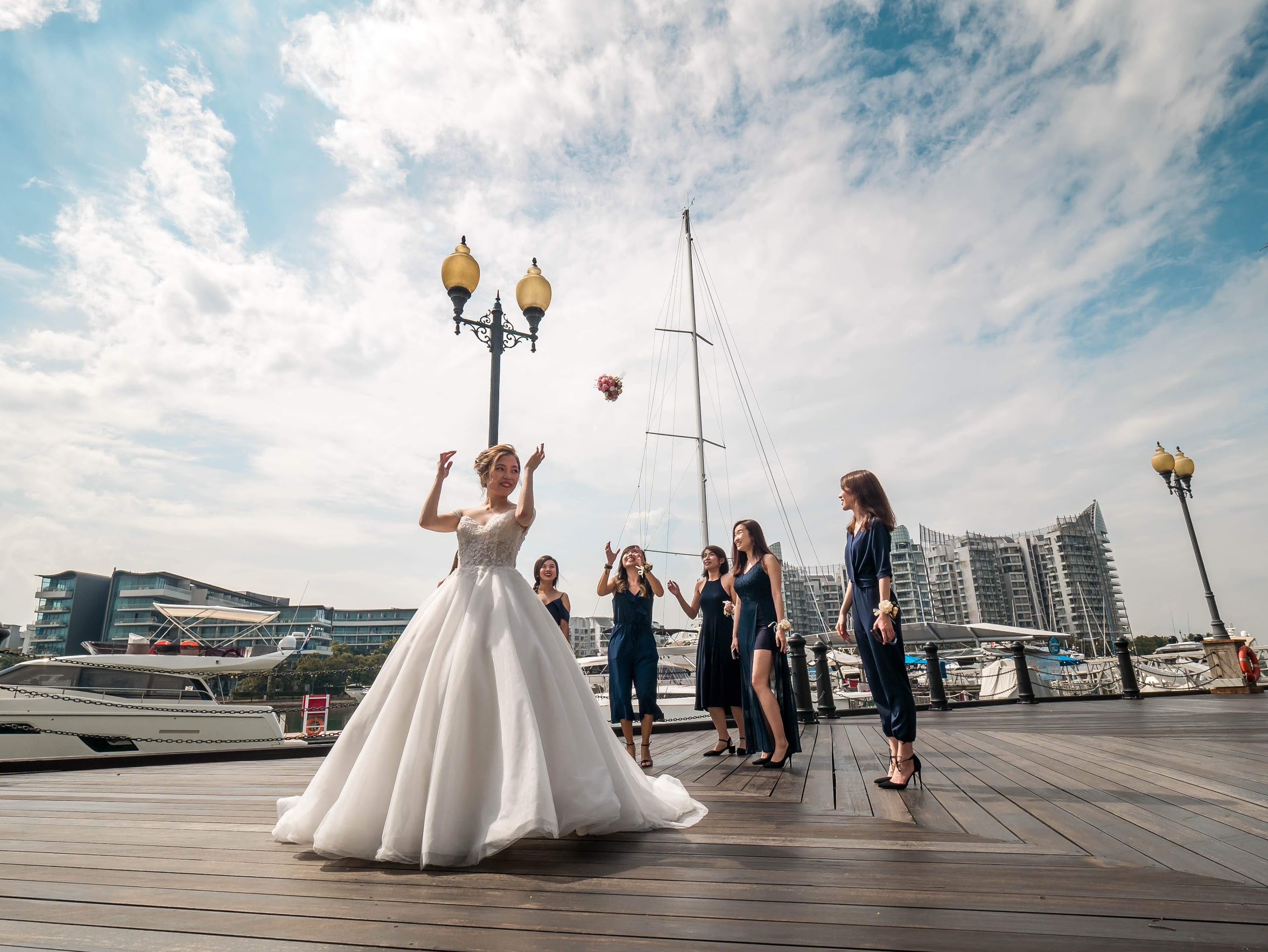 bride throwing flower bouquet